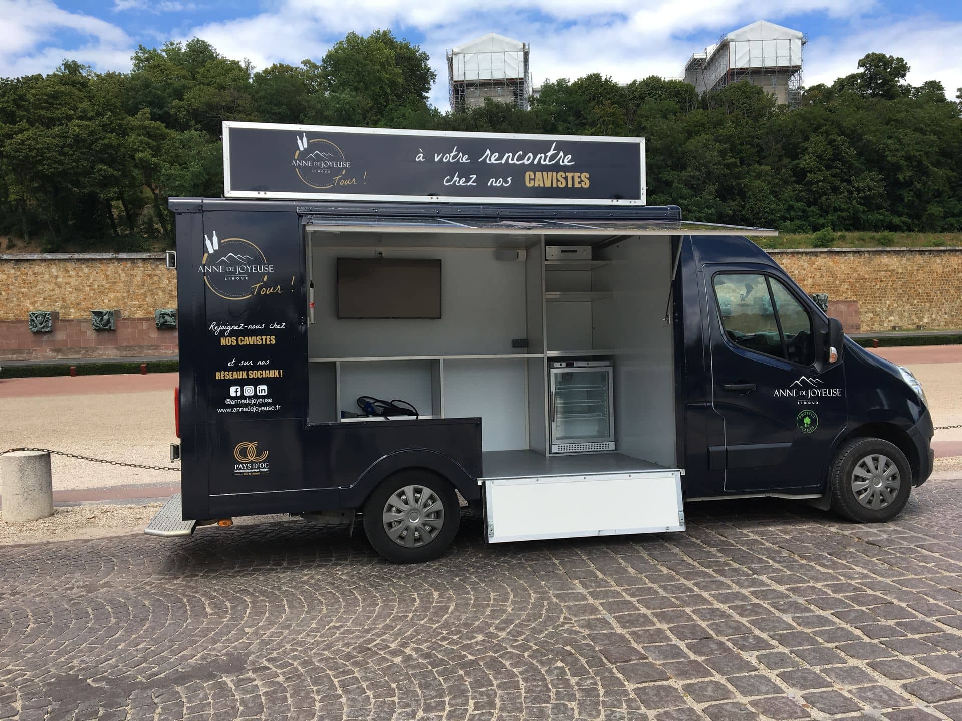 Camion Anne de Joyeuse avec auvent relevé et comptoir ouvert, vue de profil