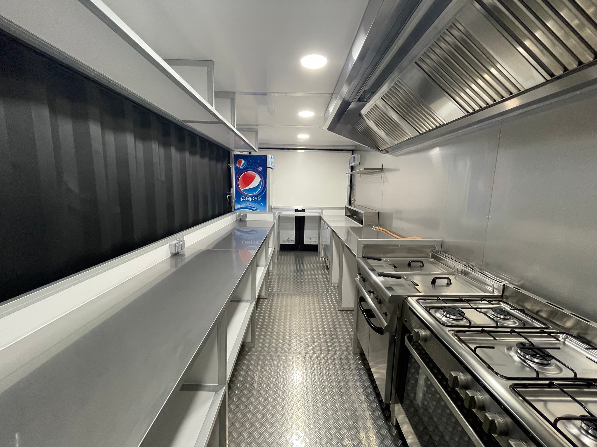 Intérieur d'un container snack - cuisine professionnelle inox complète avec équipements de restauration